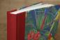 Preview: High-quality photo album with a red linen spine and a parrot motif